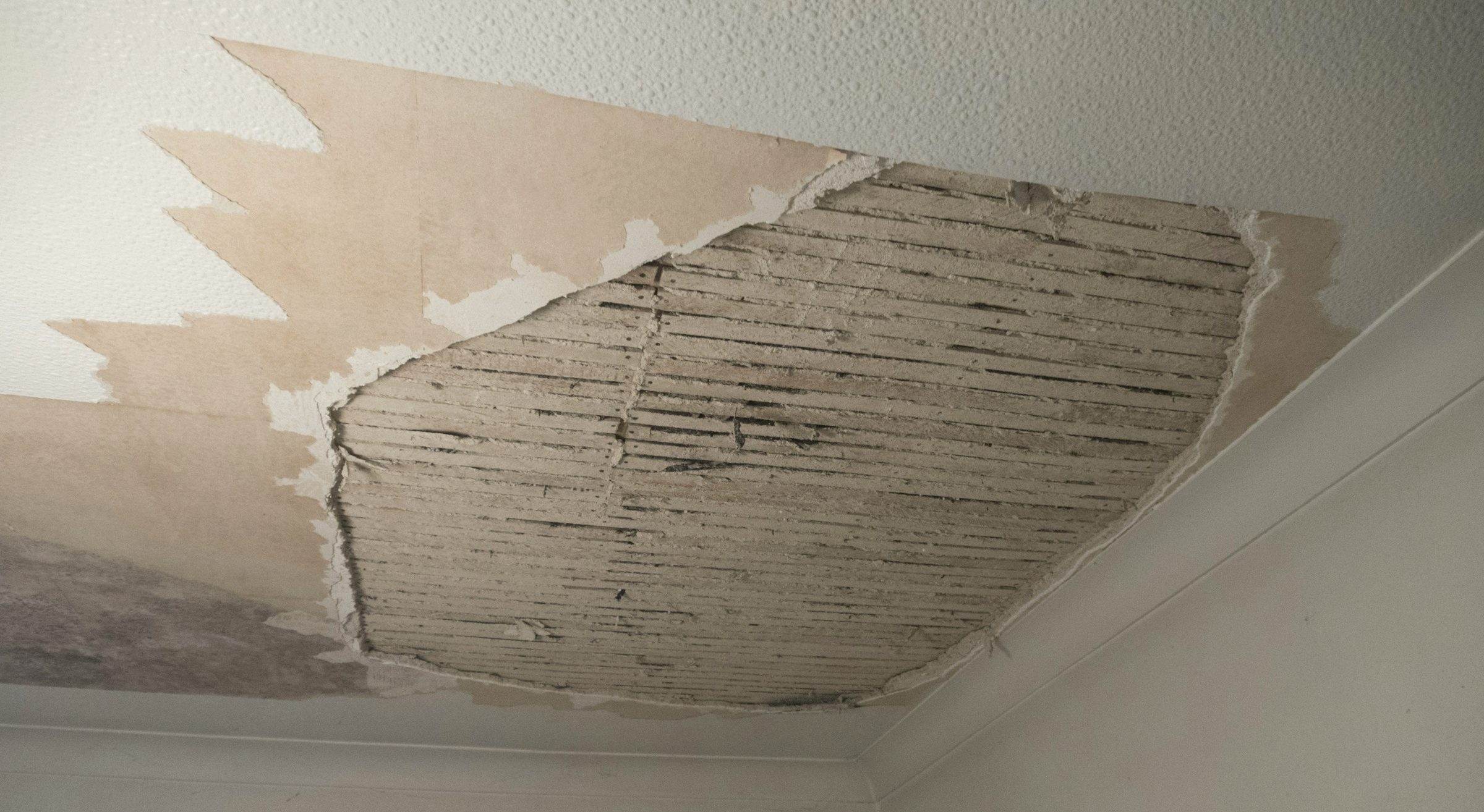 Ceiling with plaster torn away to the lath after water damage