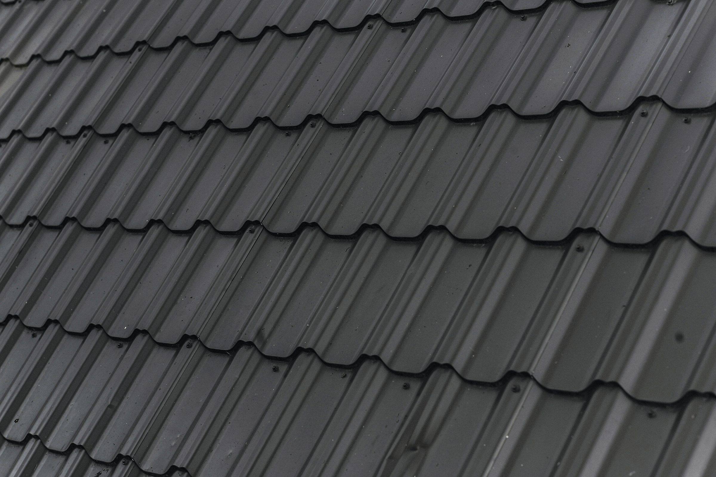 Close-up of a dark metal tile roof
